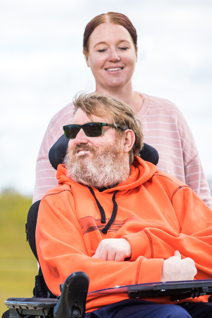 Image of a support worker and client who is in a wheel chair