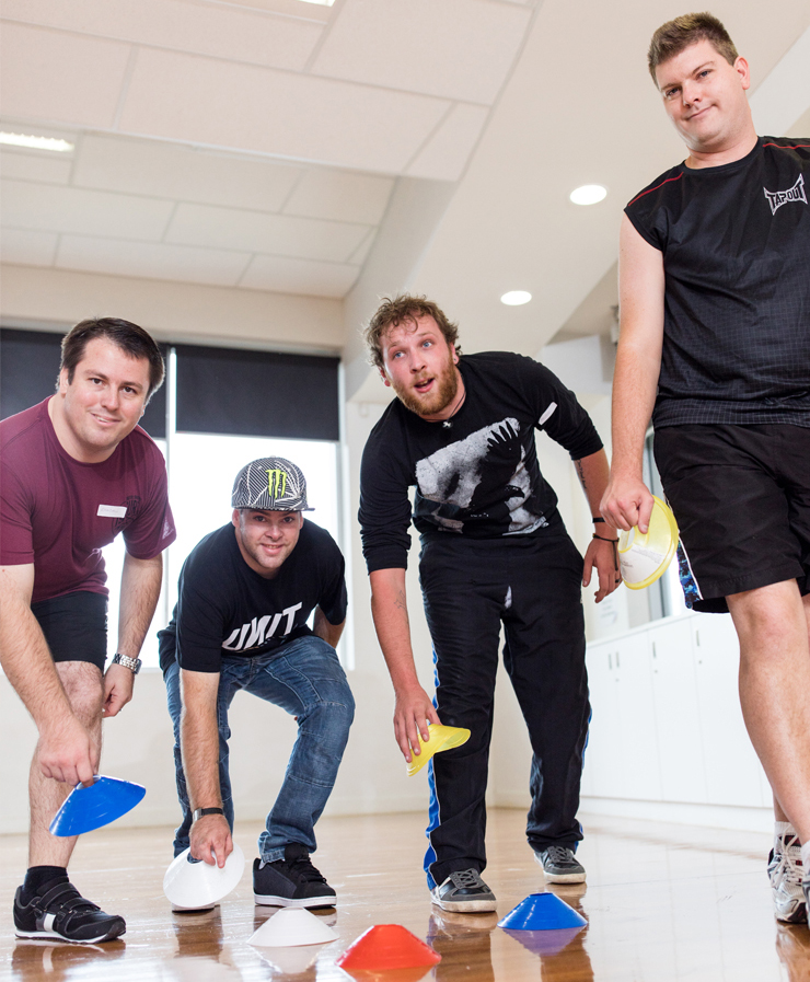 Image of 4 young men enjoying fitness activities at a disability day program