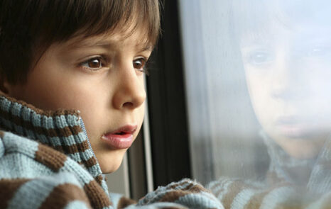 young boy looking out a window