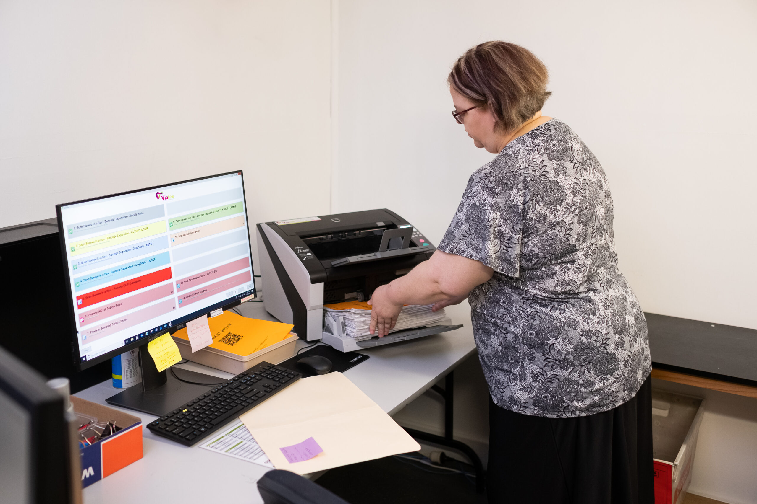 woman scanning documents and editing files on a computer at Secure Scanning Solutions Tamworth